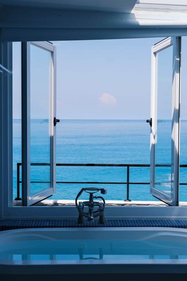 Luxury bathroom with freestanding bathtub overlooking the ocean