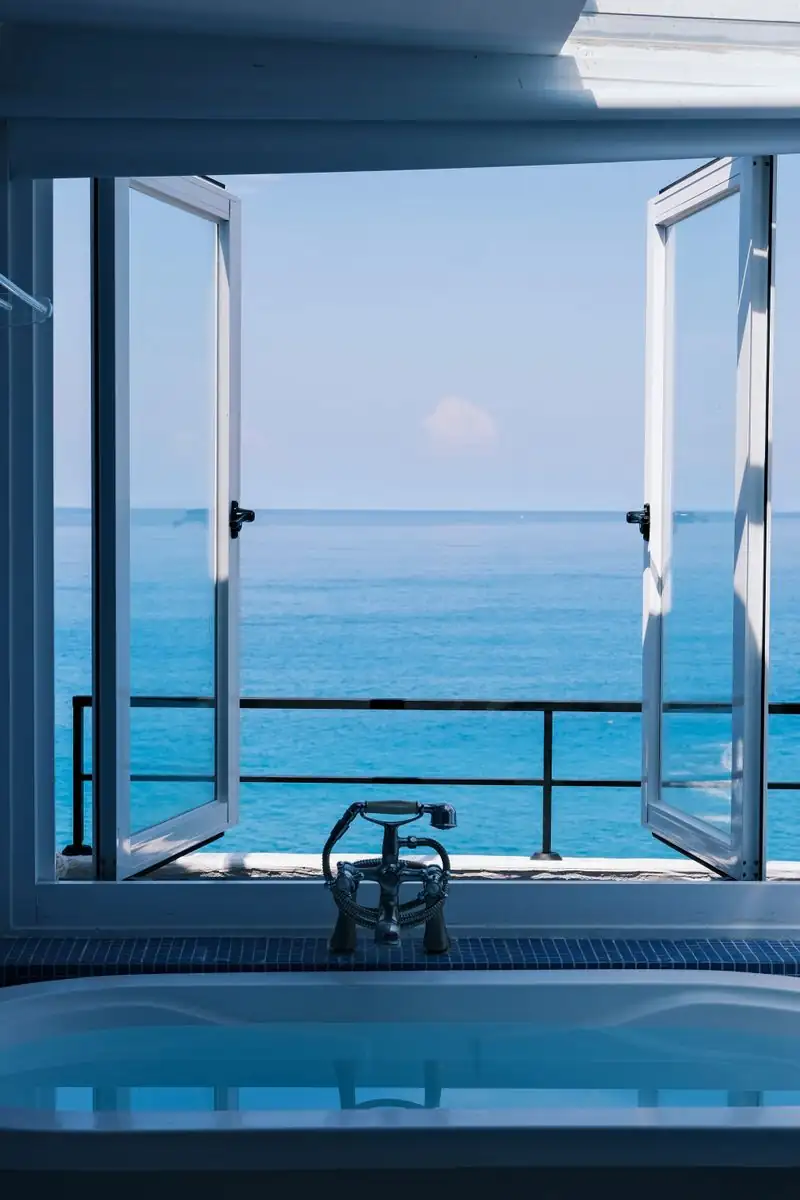 Luxury bathroom with freestanding bathtub overlooking the ocean